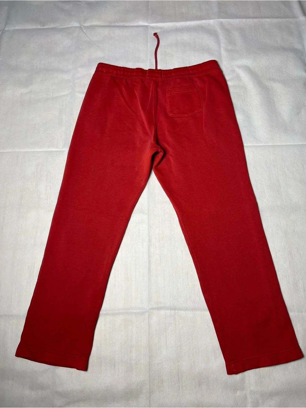Hollister Co. red sweatpants with white vertical text reading 'HOLLISTER'